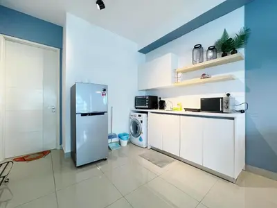 a kitchen with a refrigerator and a washing machine at Arte Plus Ampang By The Relaxstay in Kuala Lumpur
