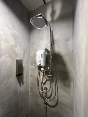 a shower in a bathroom with a shower head at The Freedom Club Hostel KL in Kuala Lumpur