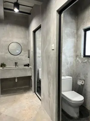 a bathroom with a toilet and a sink and a mirror at The Freedom Club Hostel KL in Kuala Lumpur