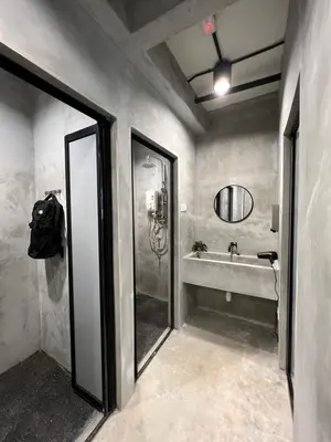 a bathroom with a shower and a sink at The Freedom Club Hostel KL in Kuala Lumpur