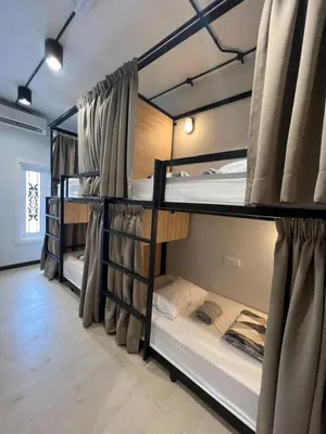 a group of bunk beds in a room at The Freedom Club Hostel KL in Kuala Lumpur