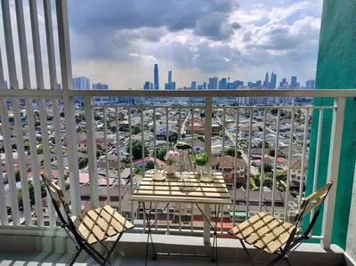 a table and chairs on a balcony with a view of a city at Ampang 2-4 pax Studio AmpPoint in Ampang