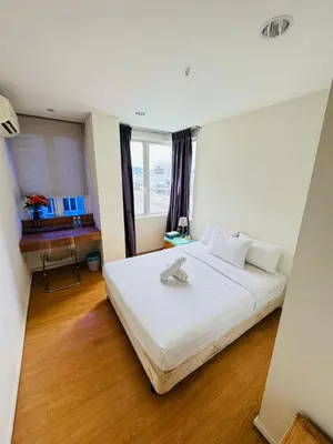 a large white bed in a room with a window at Bintang Goldhill Guest House in Kuala Lumpur