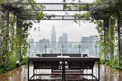 a table with chairs and a view of a city at Romantic Log Cabin 2 - Heart of KL, near KLCC/KL Tower in Kuala Lumpur