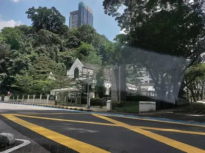 an empty street with a church and a building at Romantic Log Cabin 2 - Heart of KL, near KLCC/KL Tower in Kuala Lumpur