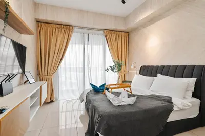 a hotel room with a bed and a window at Cozy Studio near TRX By Rumabnb in Kuala Lumpur