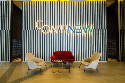 a store with three chairs and a red couch at Cozy Studio near TRX By Rumabnb in Kuala Lumpur