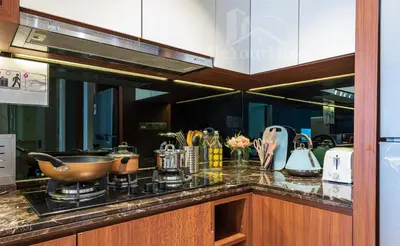 a kitchen with a counter with a stove and appliances at Anggun Residences Luxury Suites KL City Center in Kuala Lumpur