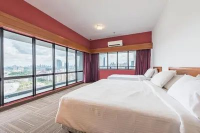 a bedroom with a large bed and large windows at Menara PGRM By Minsu in Kuala Lumpur